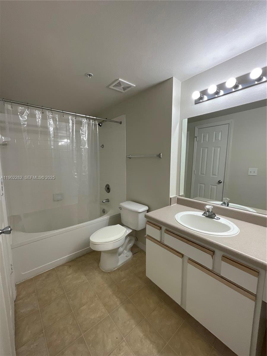 11730 Southwest 2nd Street, Unit 12202 Pembroke Pines, FL 33025 - Photo 15 of 18 a bathroom with a sink a toilet and shower