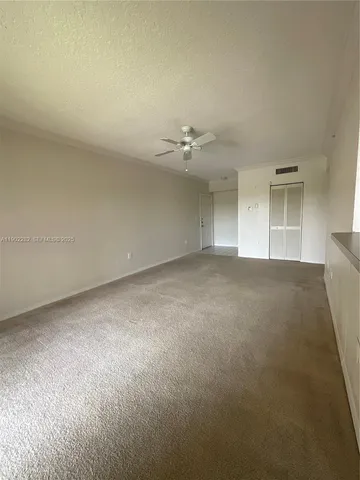 a view of a livingroom with a ceiling fan and window