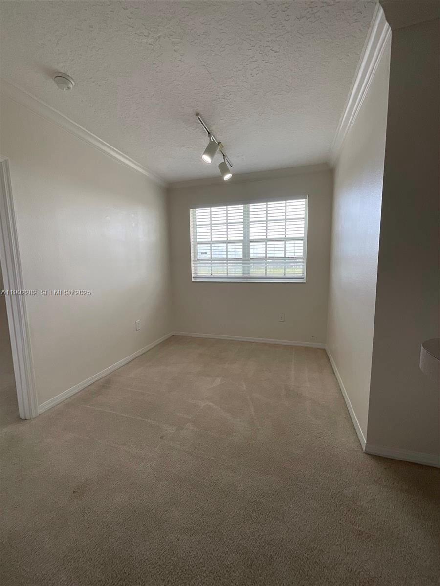 11730 Southwest 2nd Street, Unit 12202 Pembroke Pines, FL 33025 - Photo 10 of 18 an empty room with windows