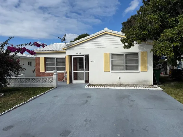 a view of a house with a garden and yard