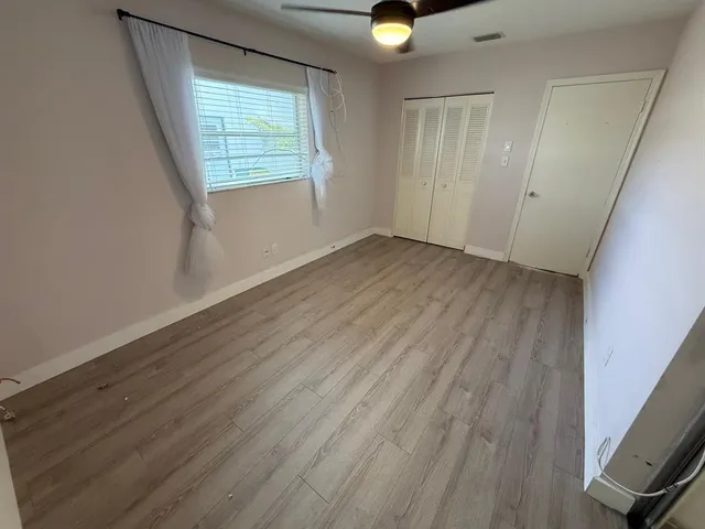 wooden floor in an empty room with a mirror