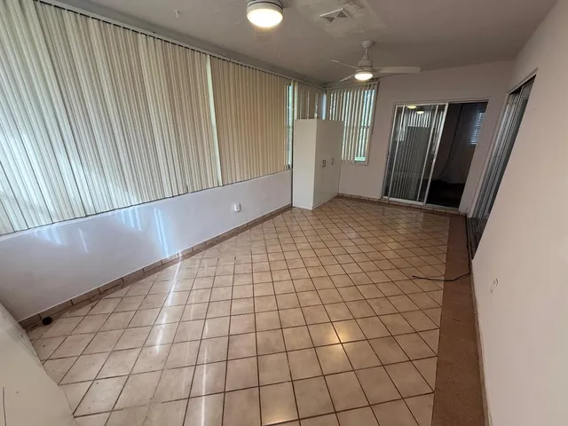 a view of an empty room and a window