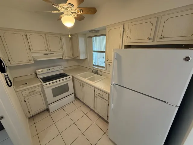 a utility room with cabinets washer and dryer