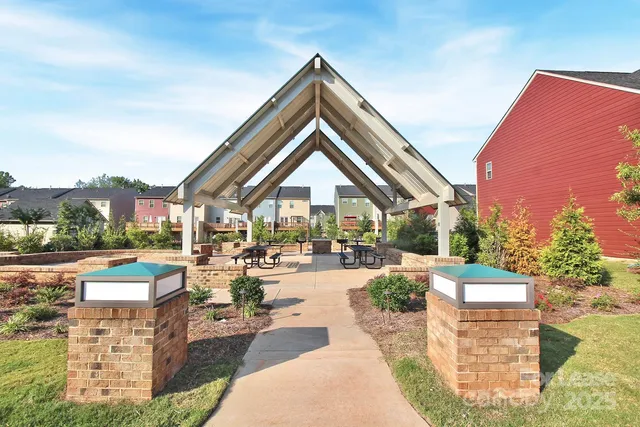 a living room with patio furniture and a large window