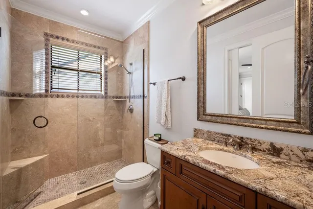 a white room with wooden floor and windows