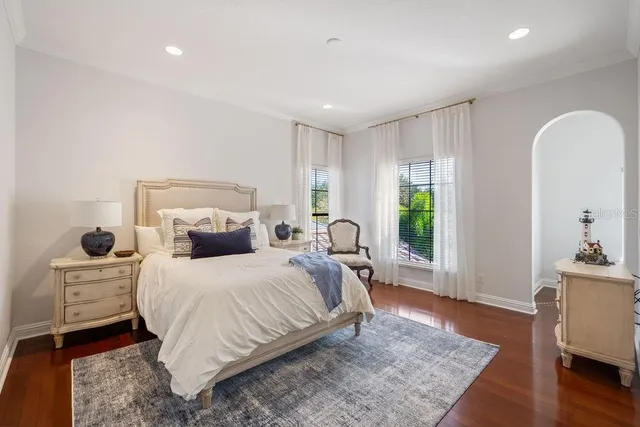 a bathroom with a granite countertop sink a toilet a mirror and shower