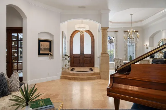 a living room with furniture and a chandelier