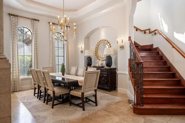 a living room with furniture chandelier and a large window
