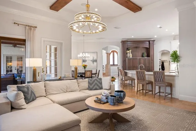 a living room with furniture a flat screen tv and a large window