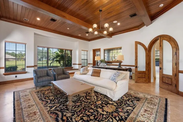 a living room with furniture and a floor to ceiling window