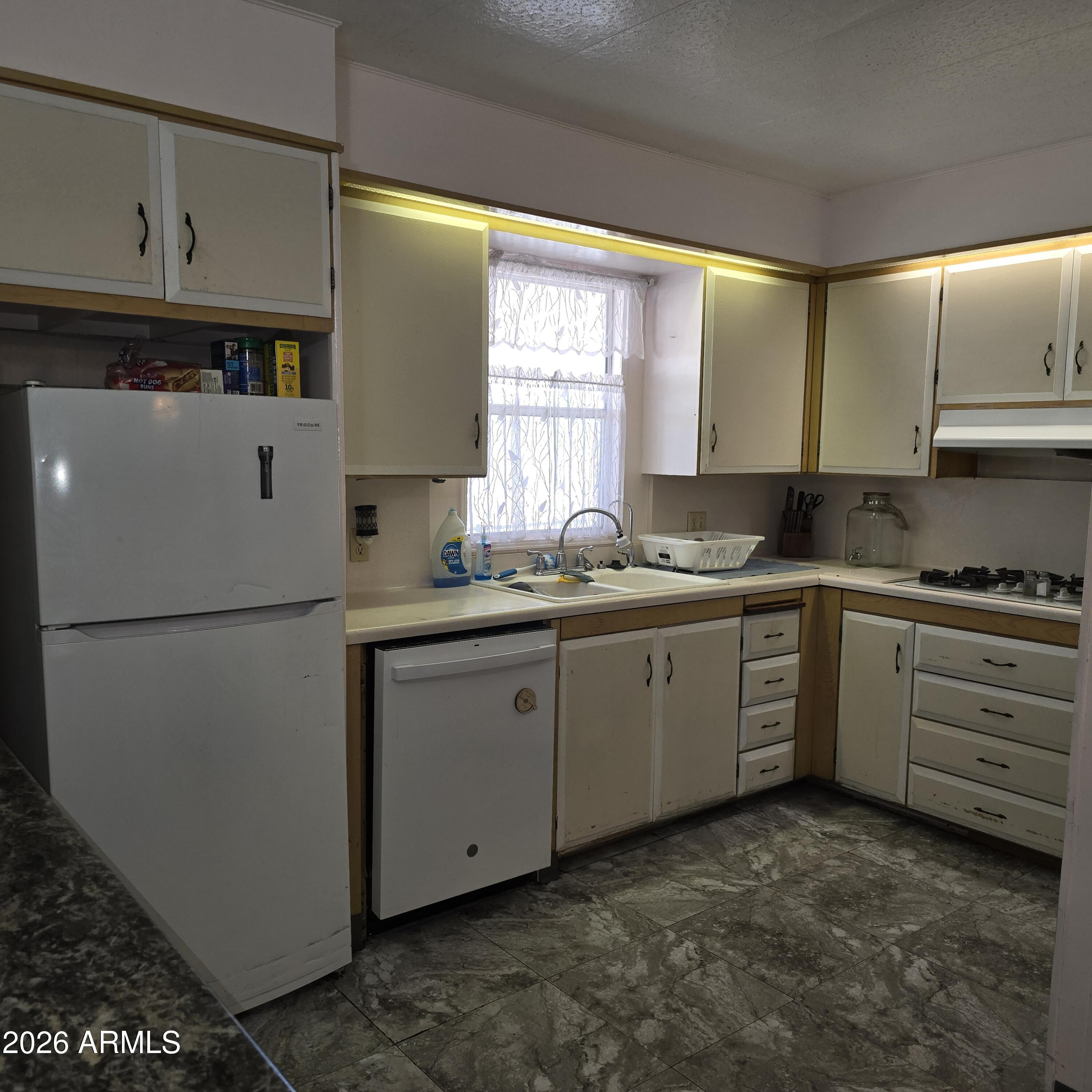 4800 West Ocotillo Road, Unit 154 Glendale, AZ 85301 - Photo 13 of 41 a kitchen with cabinets appliances and a window