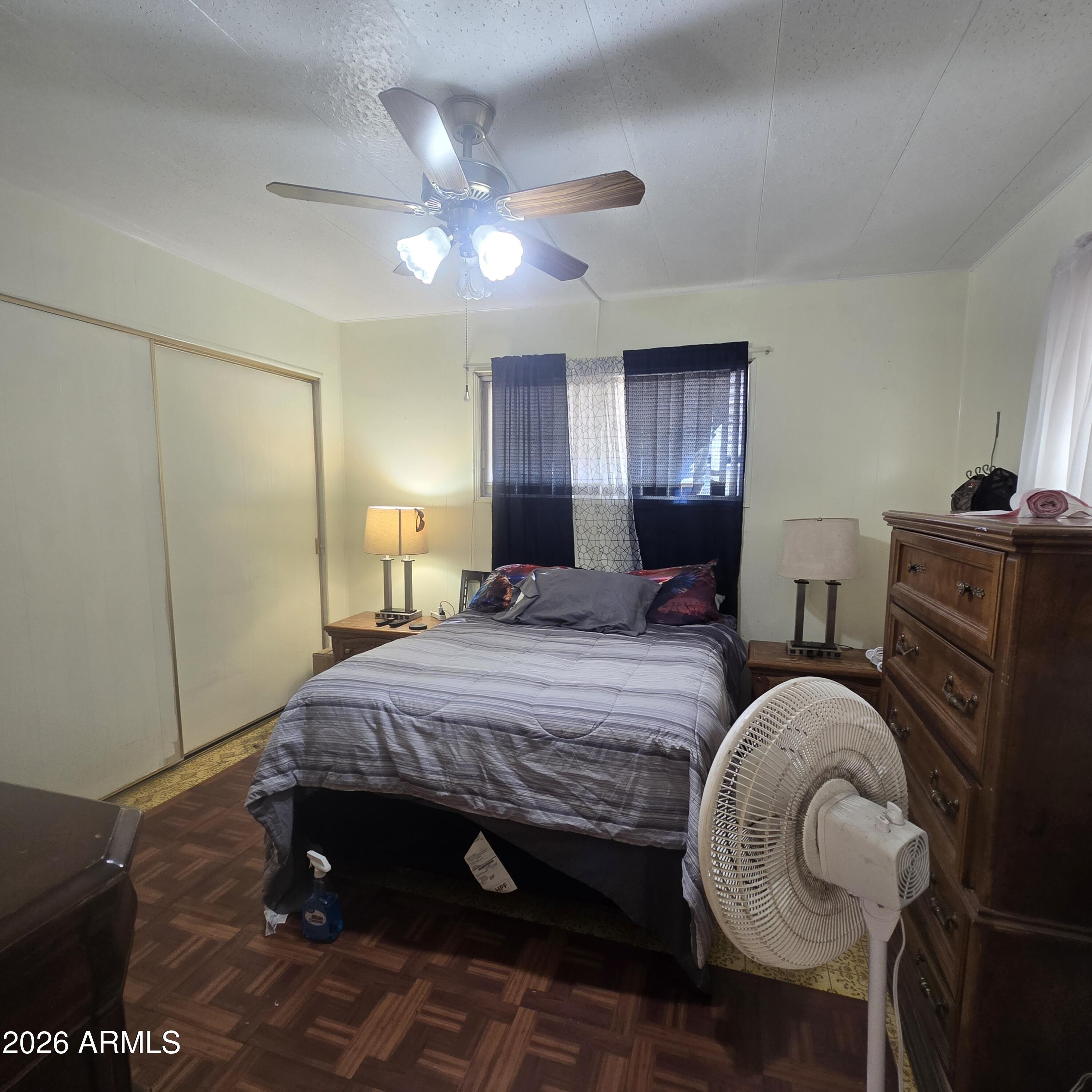 4800 West Ocotillo Road, Unit 154 Glendale, AZ 85301 - Photo 19 of 41 a bedroom with a bed and wooden floor