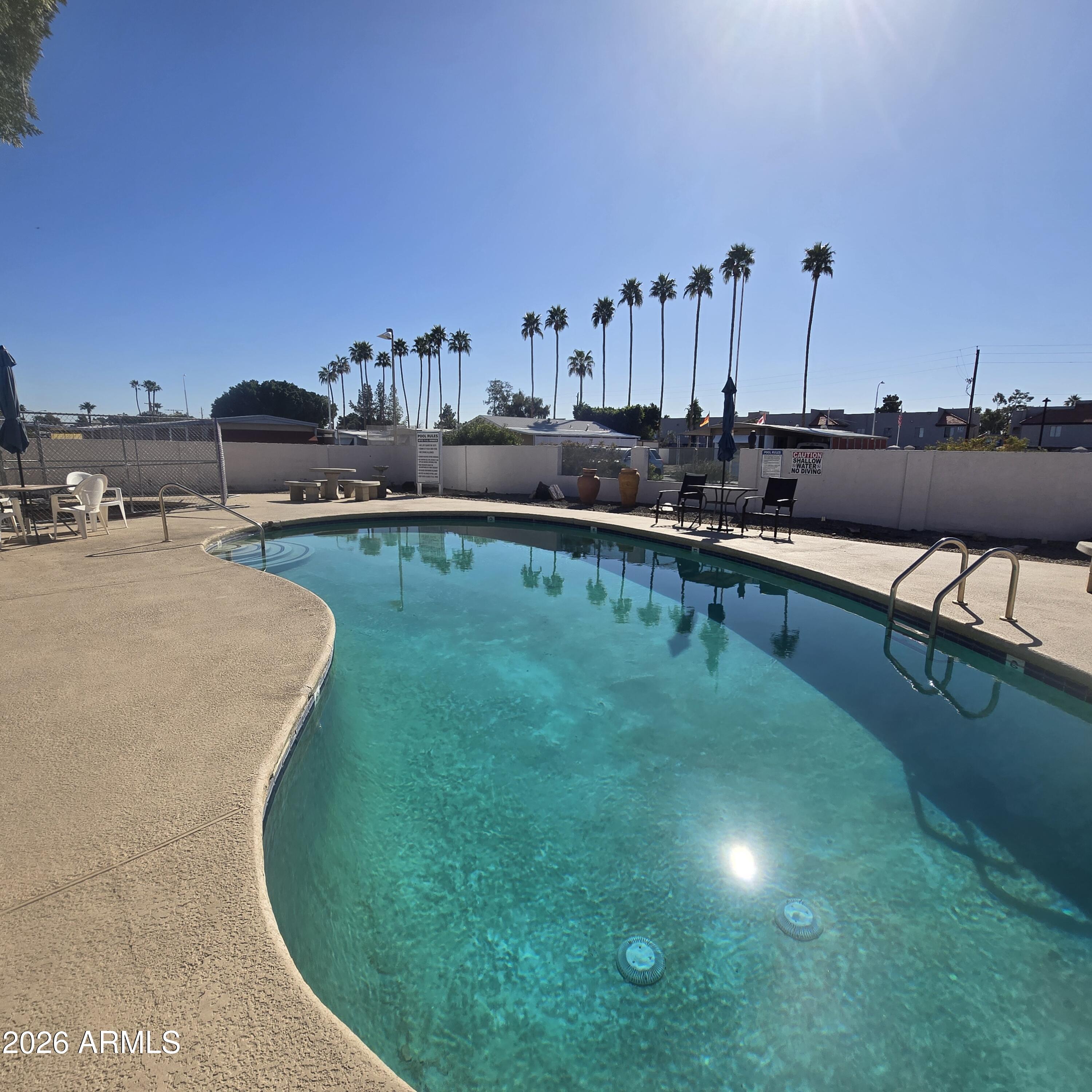 4800 West Ocotillo Road, Unit 154 Glendale, AZ 85301 - Photo 29 of 41 a view of a swimming pool and lounge chairs