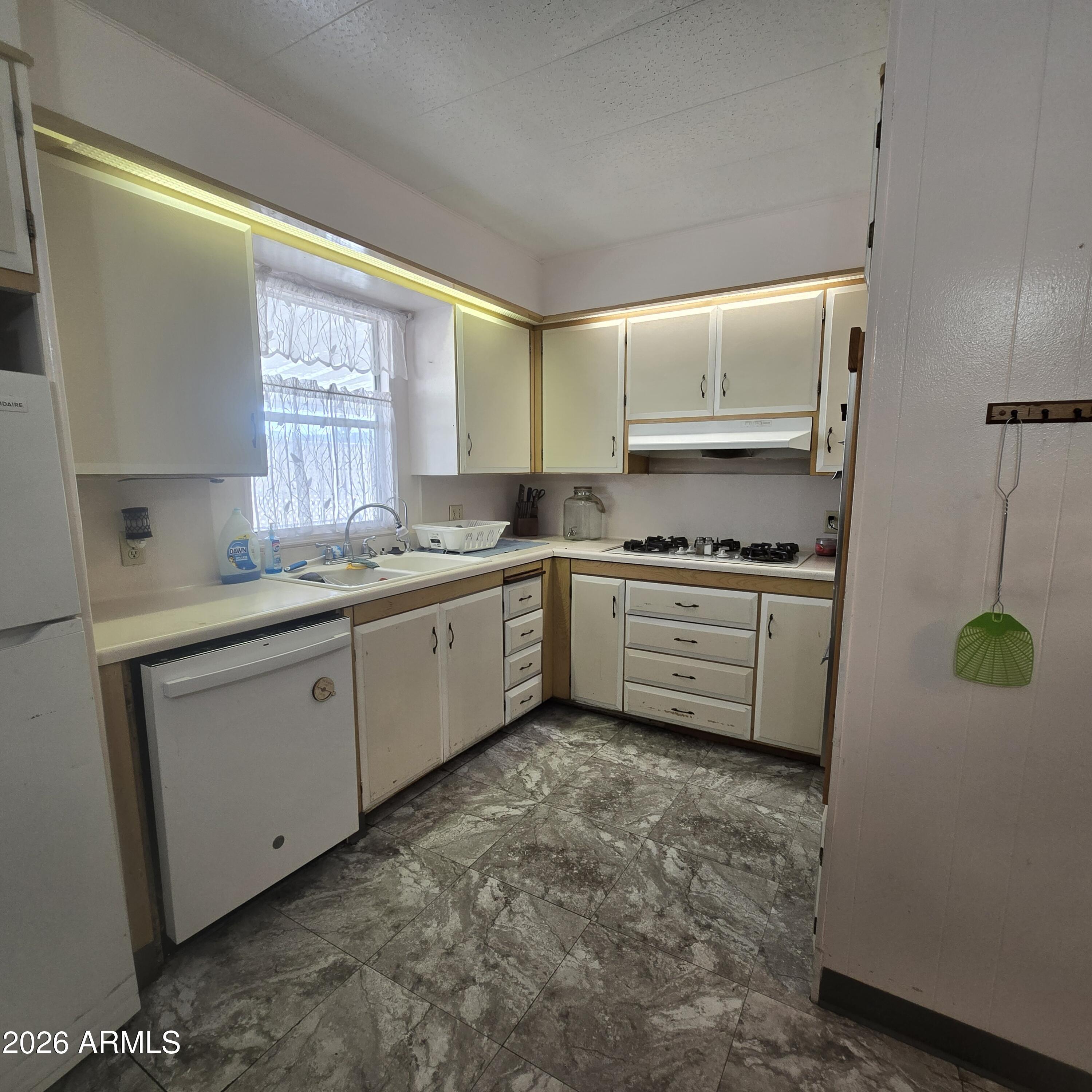 4800 West Ocotillo Road, Unit 154 Glendale, AZ 85301 - Photo 10 of 41 a kitchen with a sink cabinets and window
