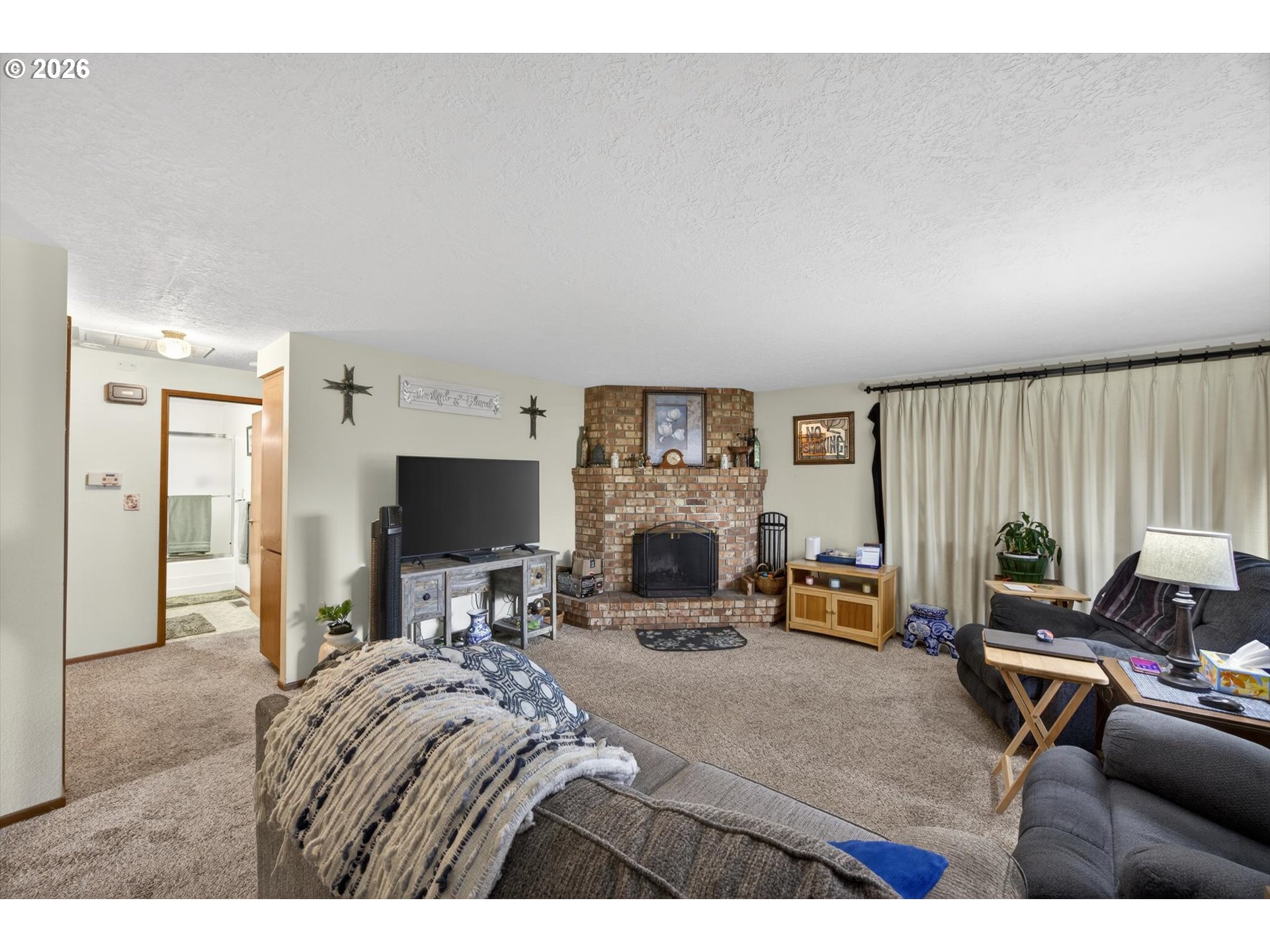 8050 Southwest 103rd Avenue Beaverton, OR 97008 - Photo 32 of 48 a living room with furniture and a flat screen tv