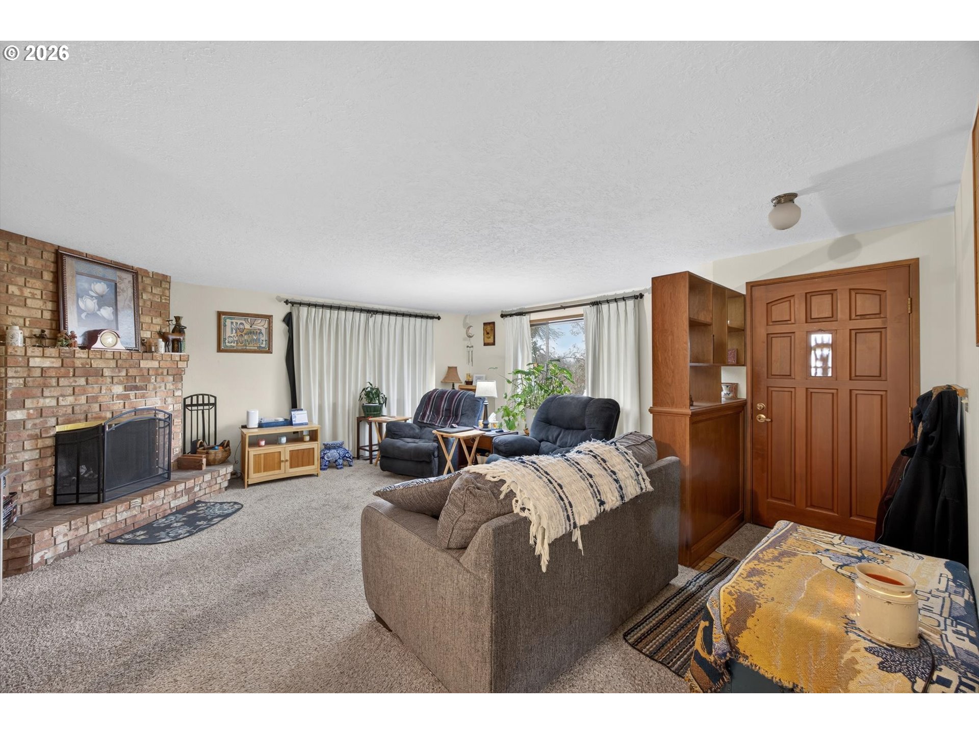 8050 Southwest 103rd Avenue Beaverton, OR 97008 - Photo 33 of 48 a living room with furniture a fireplace and a large window