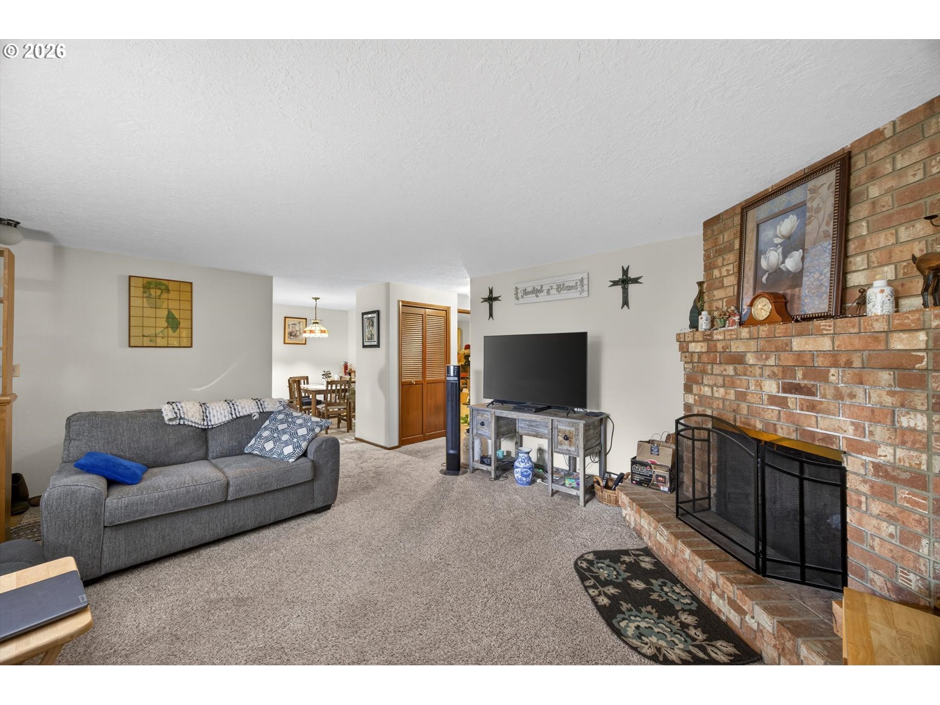 8050 Southwest 103rd Avenue Beaverton, OR 97008 - Photo 34 of 48 a living room with furniture a flat screen tv and a fireplace
