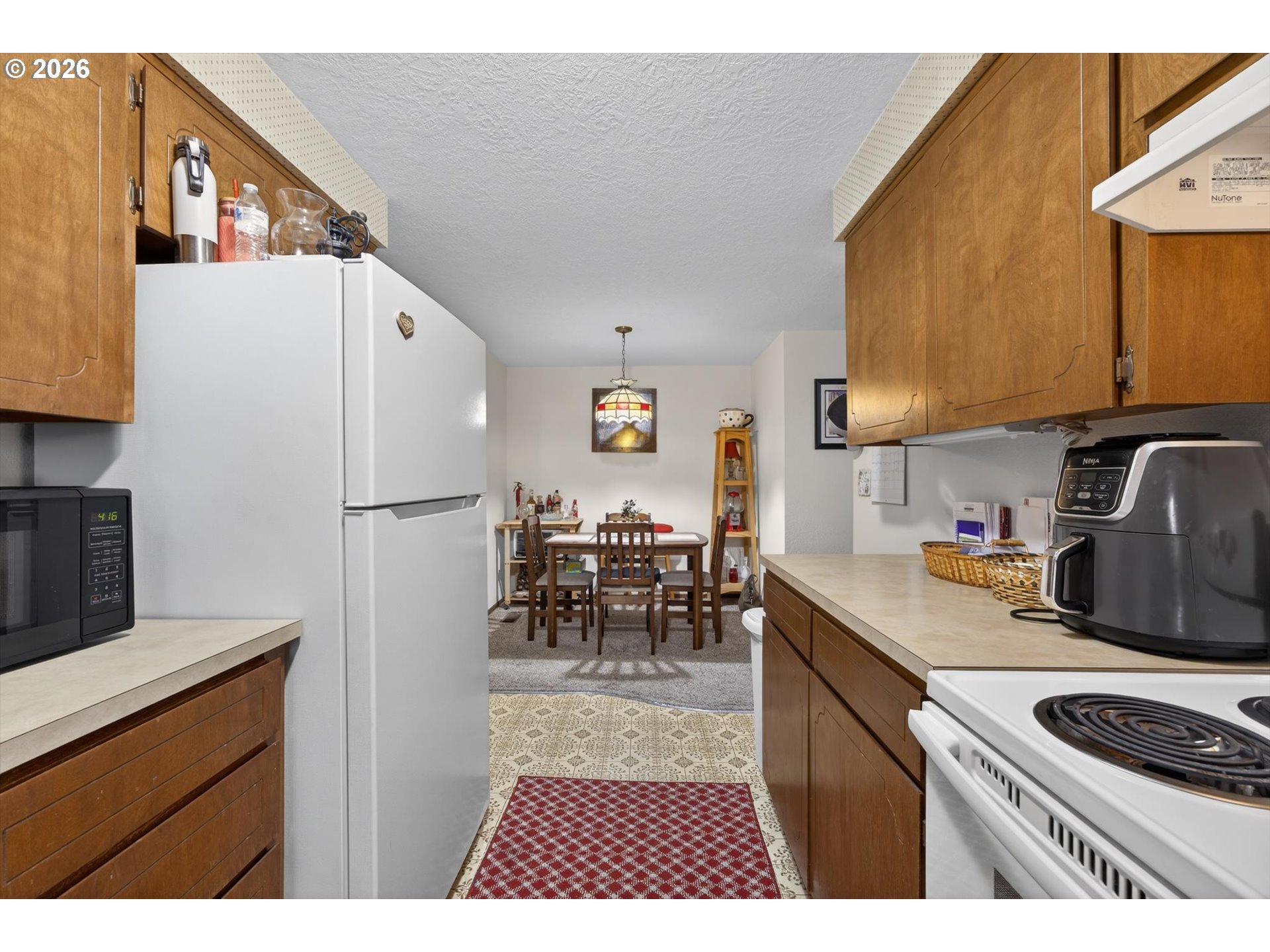8050 Southwest 103rd Avenue Beaverton, OR 97008 - Photo 43 of 48 a kitchen with refrigerator cabinets and a stove top oven