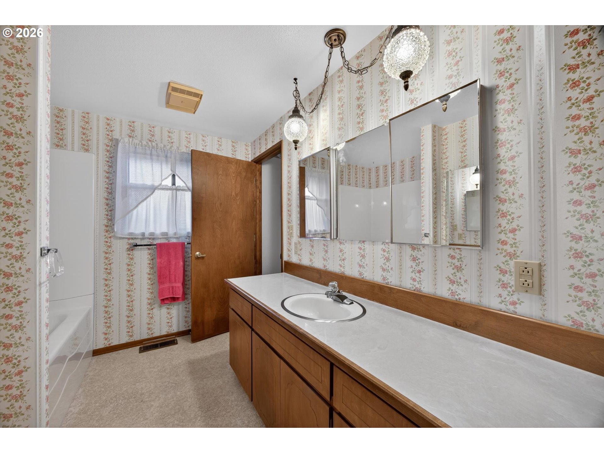 8050 Southwest 103rd Avenue Beaverton, OR 97008 - Photo 10 of 48 a bathroom with a sink vanity granite tub shower and a mirror
