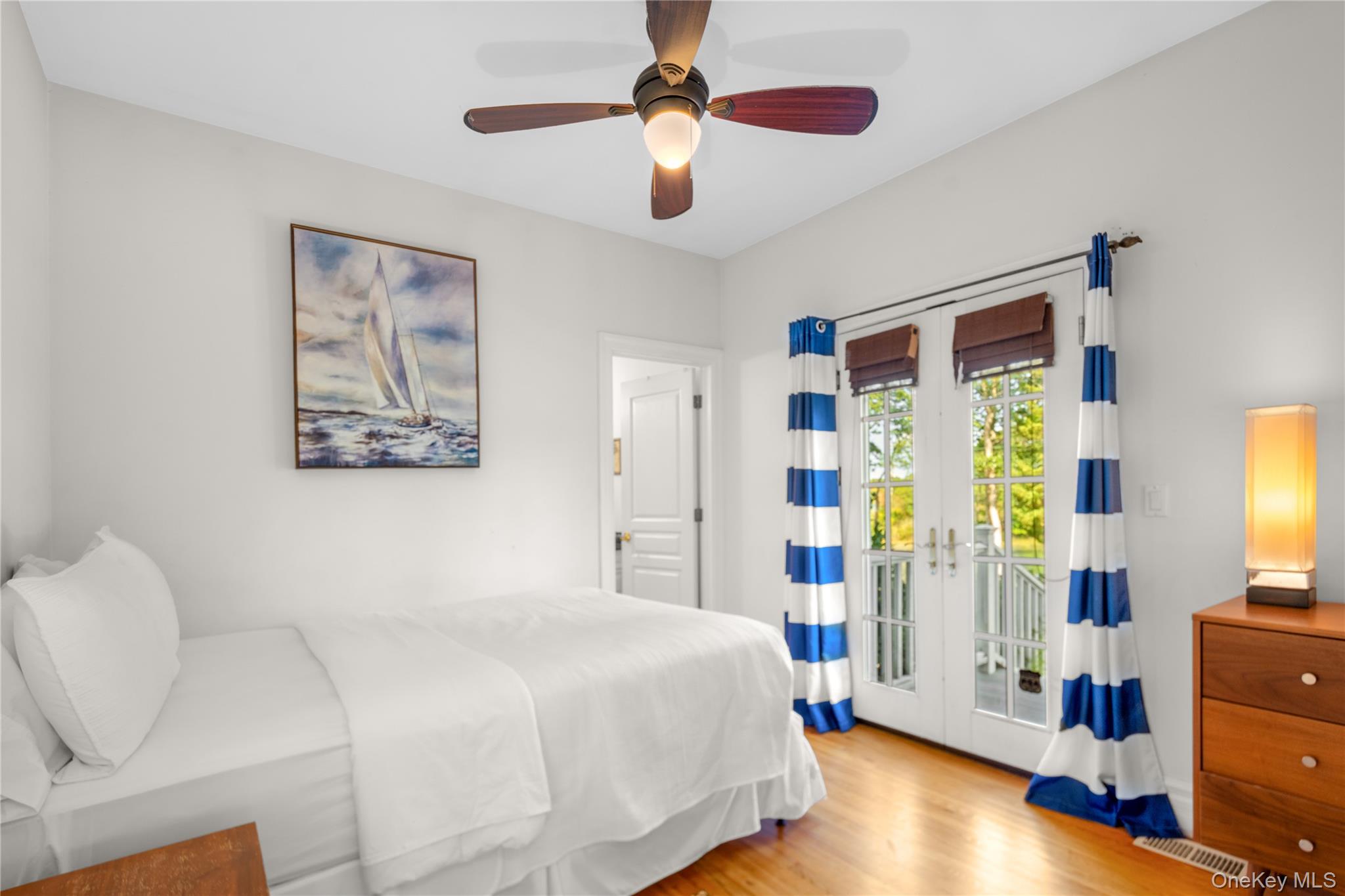 12 Fish Cove Road Southampton, NY 11968 - Photo 14 of 25 a bedroom with a bed and a chandelier