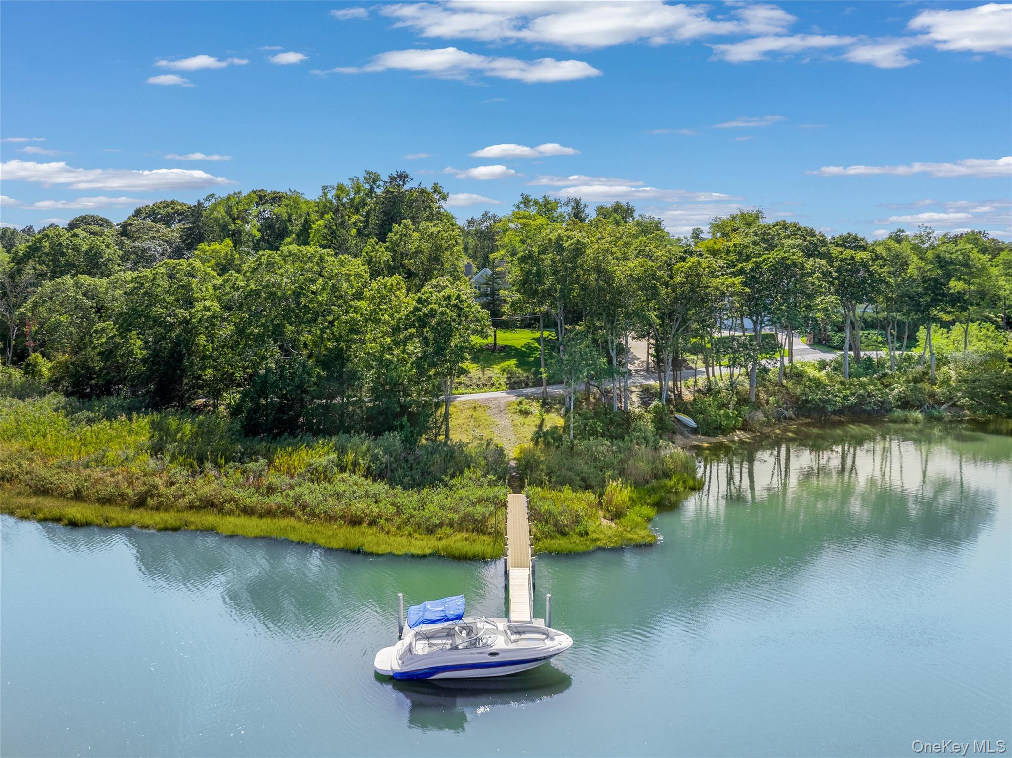 12 Fish Cove Road Southampton, NY 11968 - Photo 2 of 25 a view of a lake with a yard