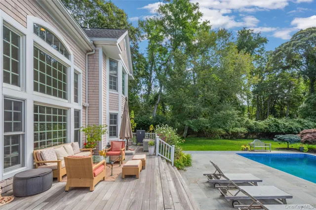 an aerial view of a residential houses with outdoor space and lake view