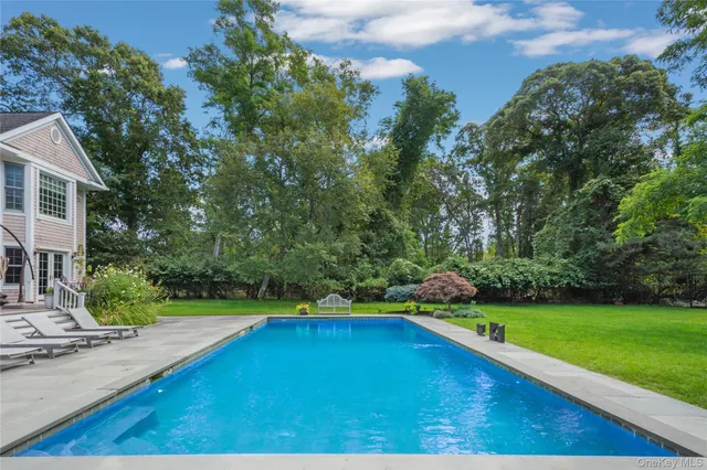 a view of a backyard with swimming pool