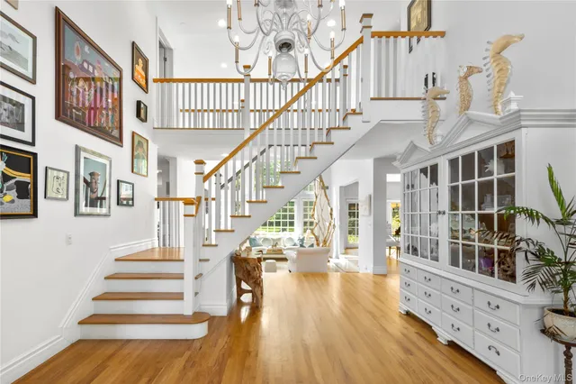 a view of staircase with lots of frames on wall and a wooden floor