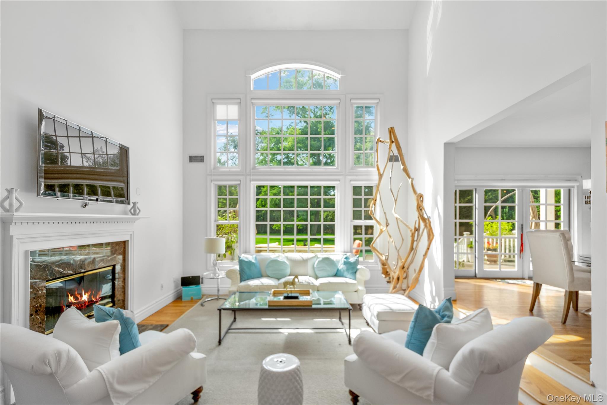12 Fish Cove Road Southampton, NY 11968 - Photo 8 of 25 a living room with furniture a fireplace and a large window