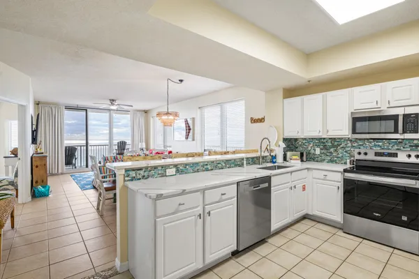 a kitchen with a sink stove and cabinets