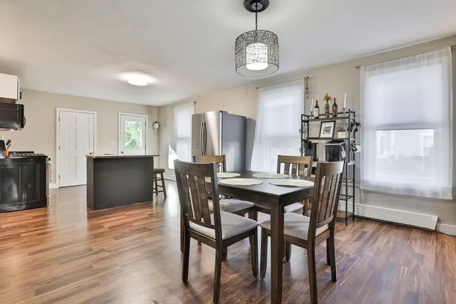 a view of a dining room with furniture and wooden floor