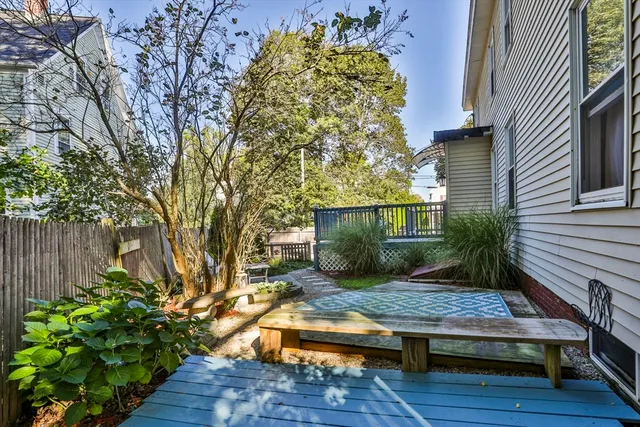 a view of backyard with a table and chairs and potted plants