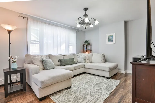 a living room with furniture and a chandelier