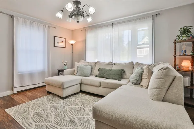 a living room with furniture and a chandelier