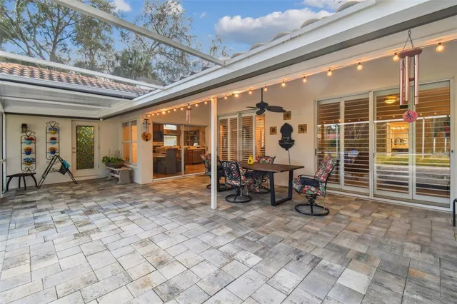 a view of a patio with table and chairs and potted plants