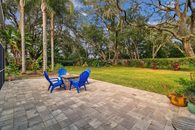 a view of a house with backyard and sitting area