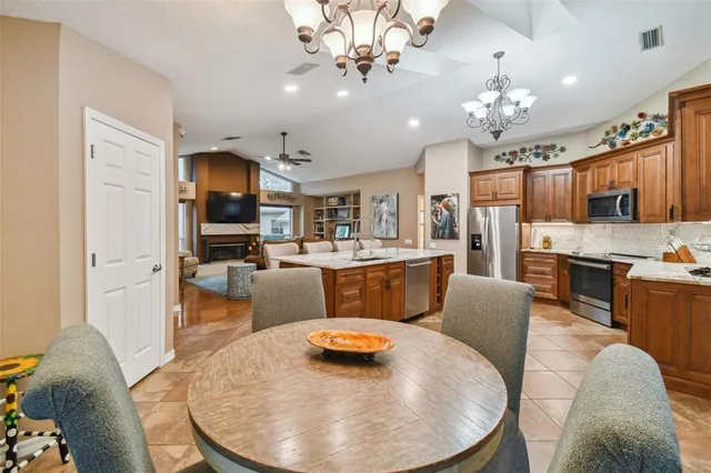 a living room with kitchen island furniture and a chandelier