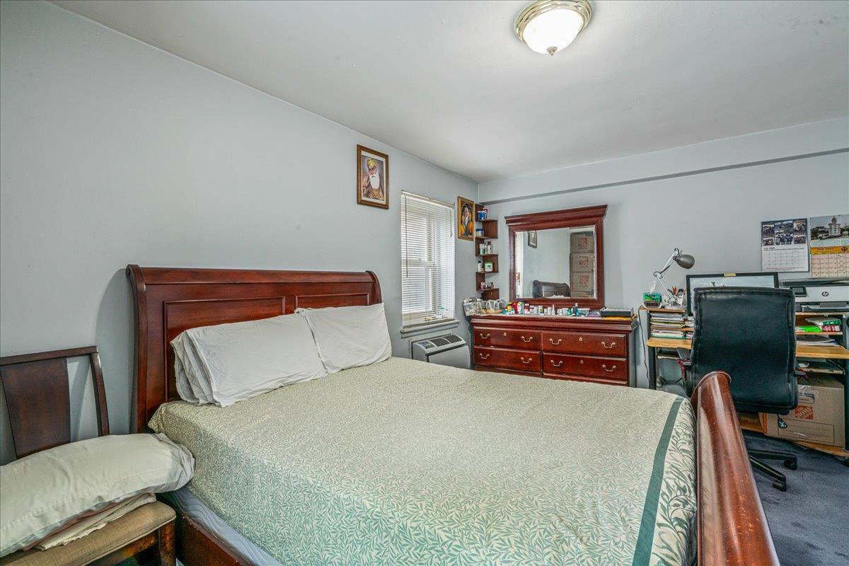 144-55 Melbourne Avenue, Unit 2E Queens, NY 11367 - Photo 11 of 21 a bedroom with a bed and wooden floor