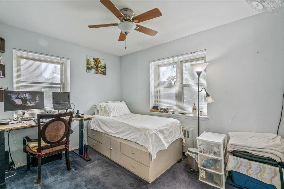 144-55 Melbourne Avenue, Unit 2E Queens, NY 11367 - Photo 13 of 21 a bedroom with a bed and a chandelier