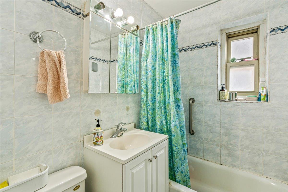 144-55 Melbourne Avenue, Unit 2E Queens, NY 11367 - Photo 14 of 21 a bathroom with a sink toilet and shower