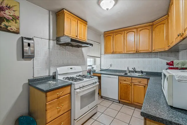 a kitchen with granite countertop cabinets stainless steel appliances and a counter space
