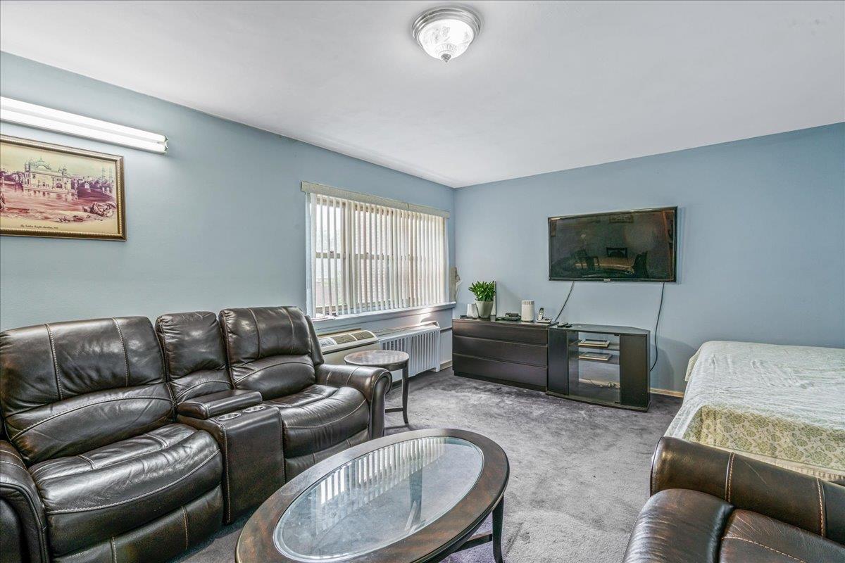 144-55 Melbourne Avenue, Unit 2E Queens, NY 11367 - Photo 6 of 21 a living room with furniture and a flat screen tv