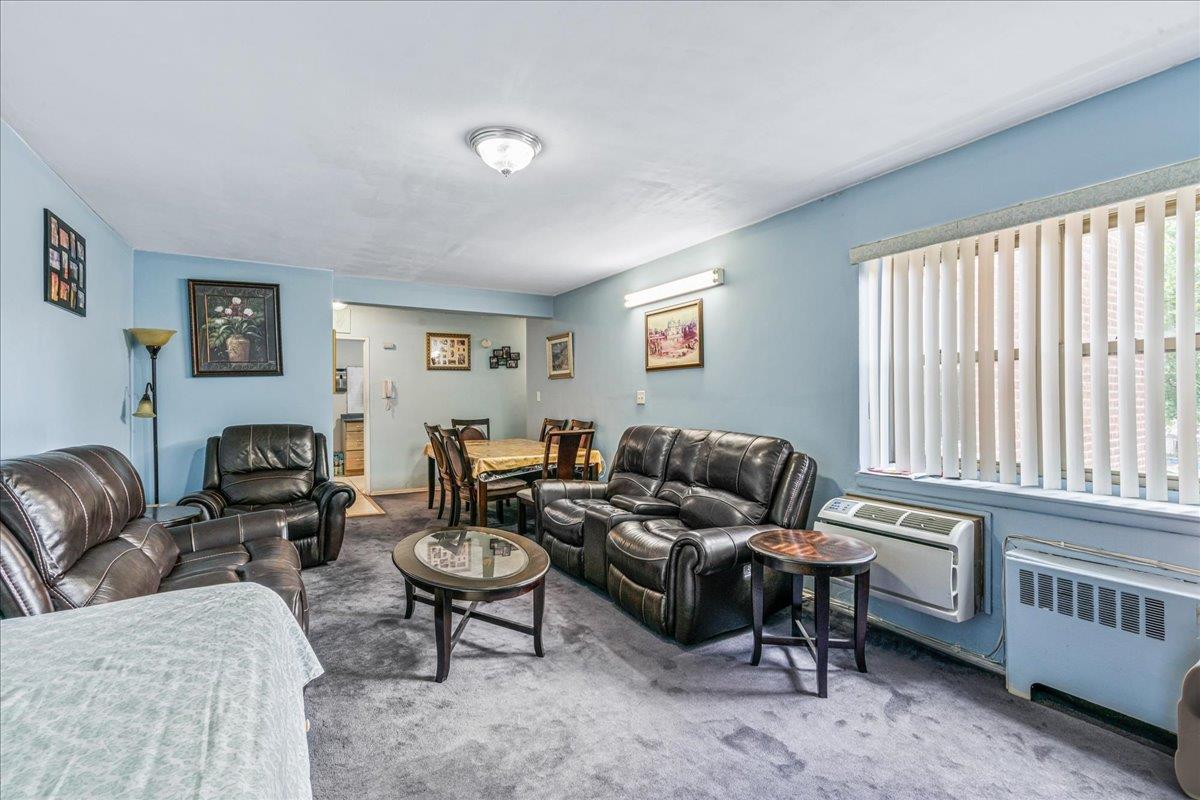 144-55 Melbourne Avenue, Unit 2E Queens, NY 11367 - Photo 8 of 21 a living room with furniture and a window