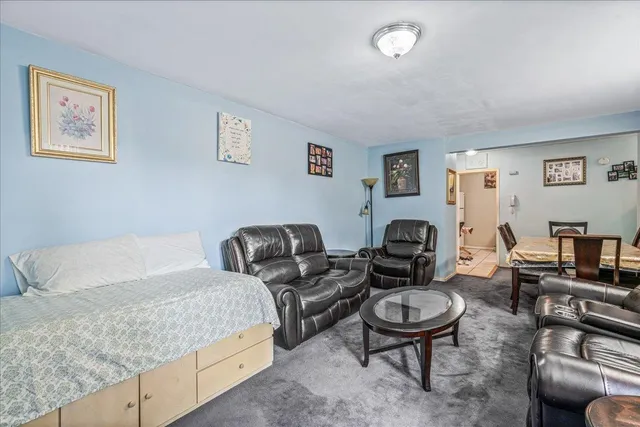 a living room with furniture and a dining table