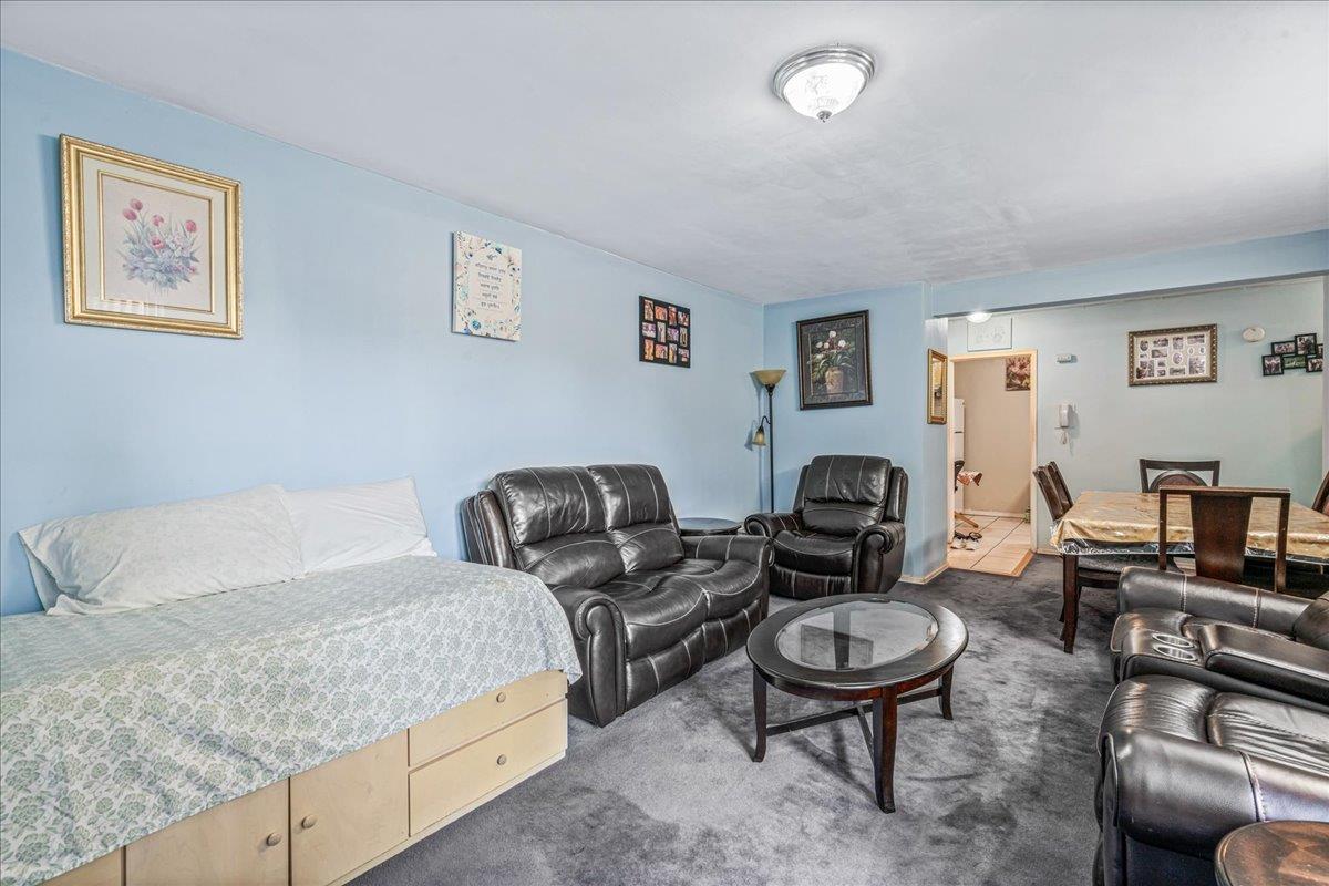 144-55 Melbourne Avenue, Unit 2E Queens, NY 11367 - Photo 9 of 21 a living room with furniture and a dining table