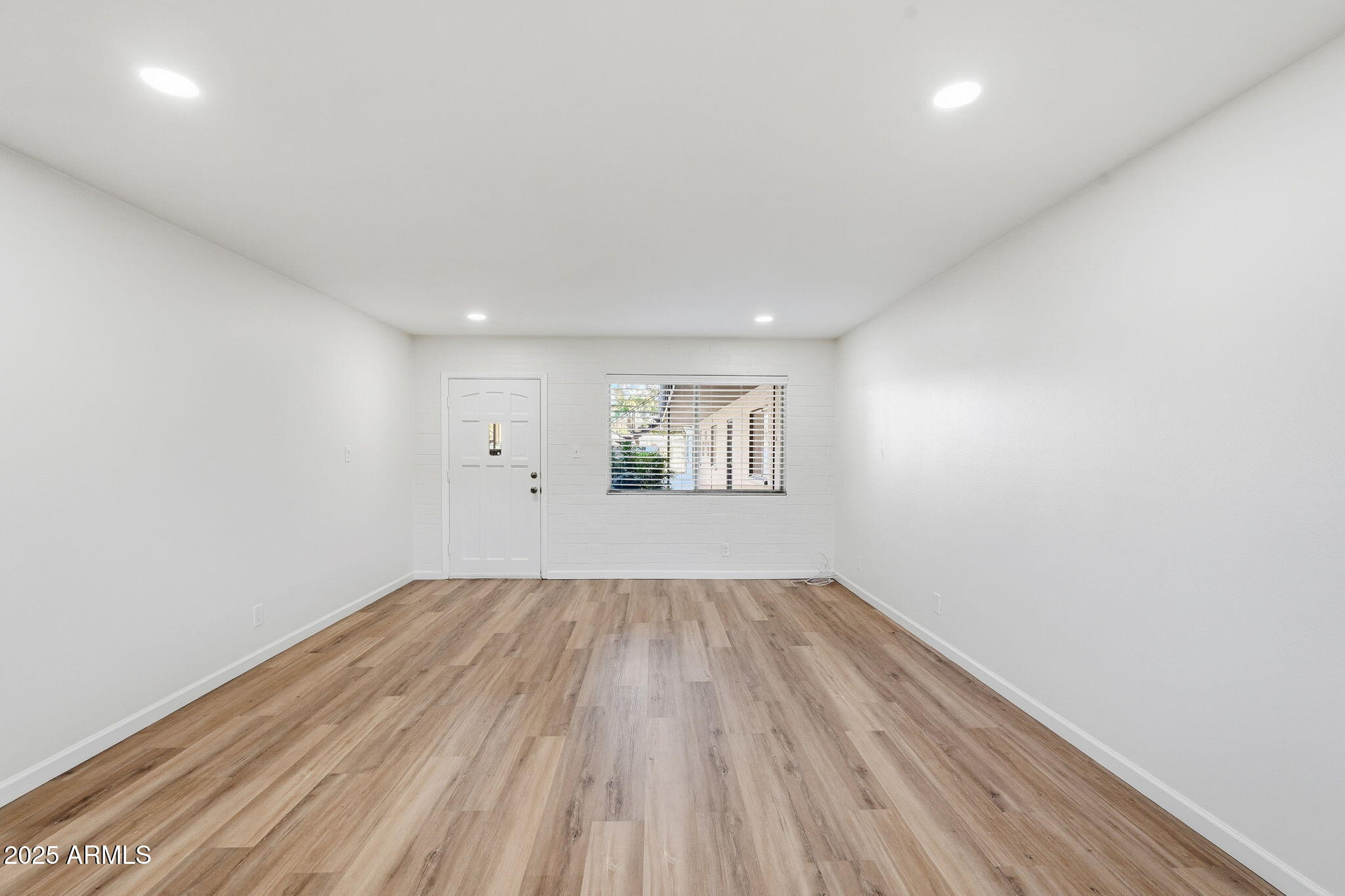 6544 North 12th Street, Unit 19 Phoenix, AZ 85014 - Photo 13 of 44 an empty room with a hardwood and ceiling fan