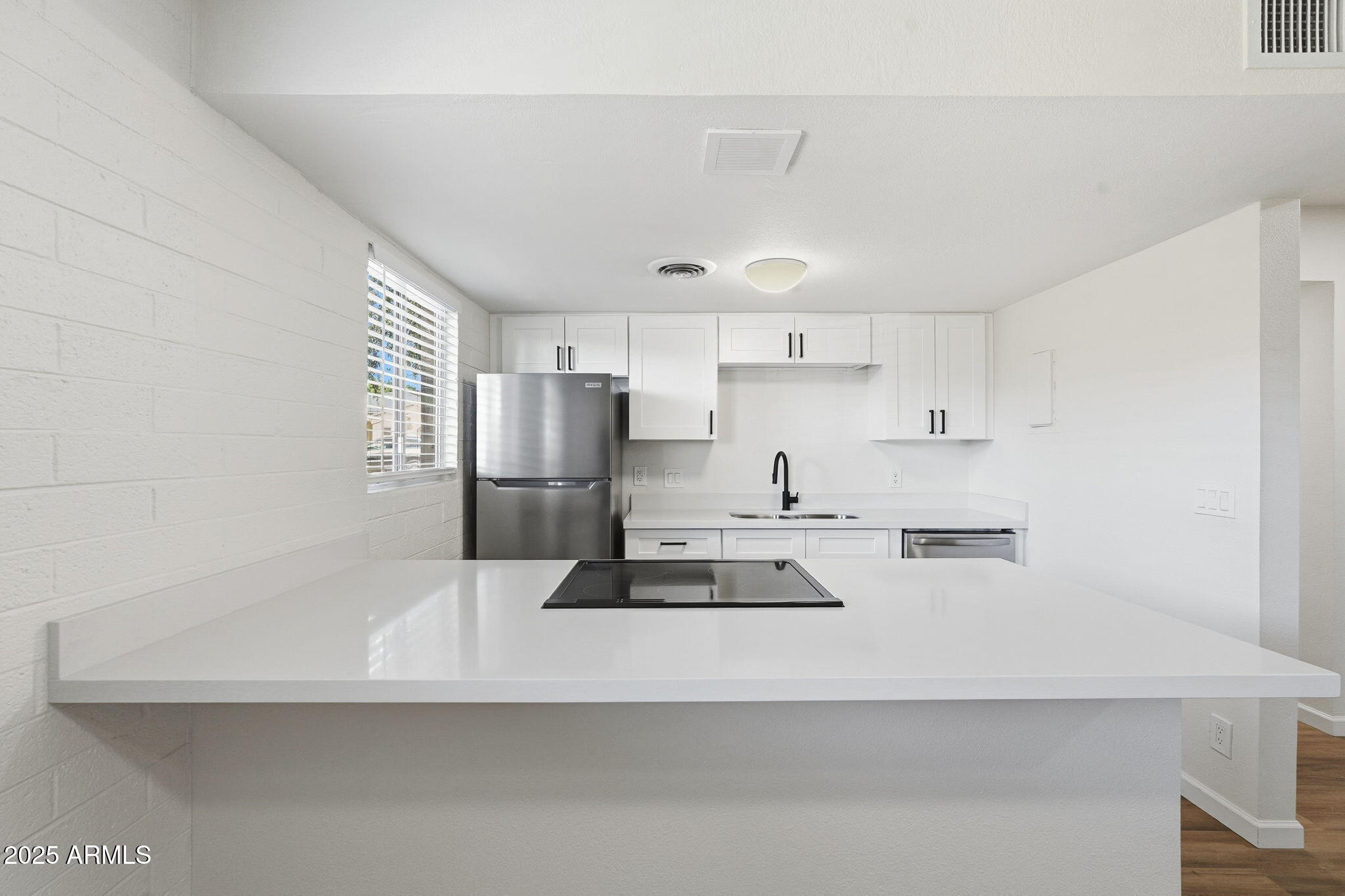 6544 North 12th Street, Unit 19 Phoenix, AZ 85014 - Photo 2 of 44 a kitchen with refrigerator and white cabinets