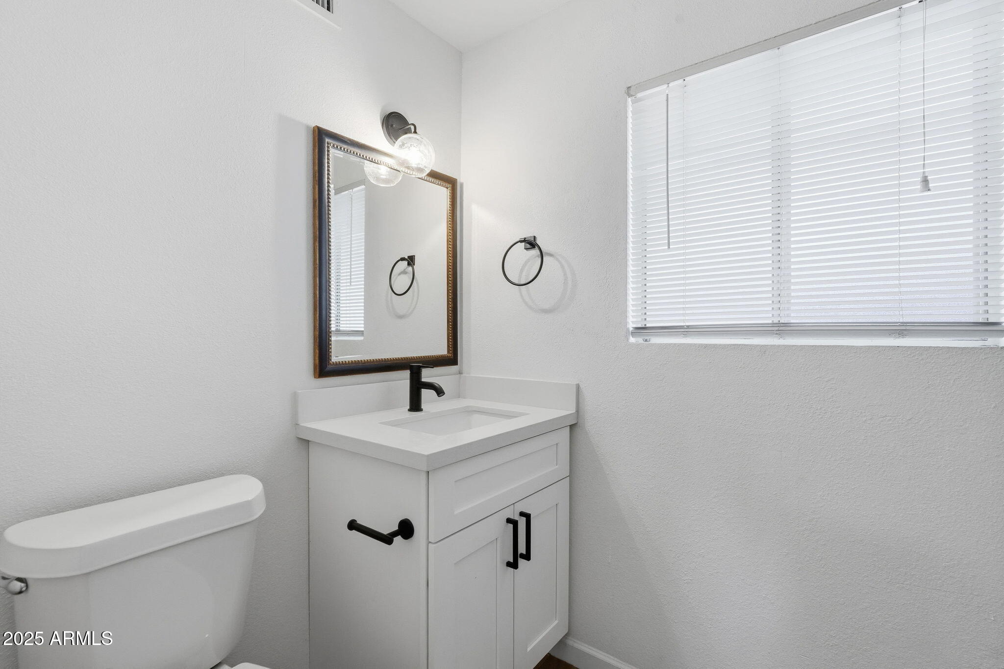 6544 North 12th Street, Unit 19 Phoenix, AZ 85014 - Photo 21 of 44 a bathroom with a sink a toilet and mirror