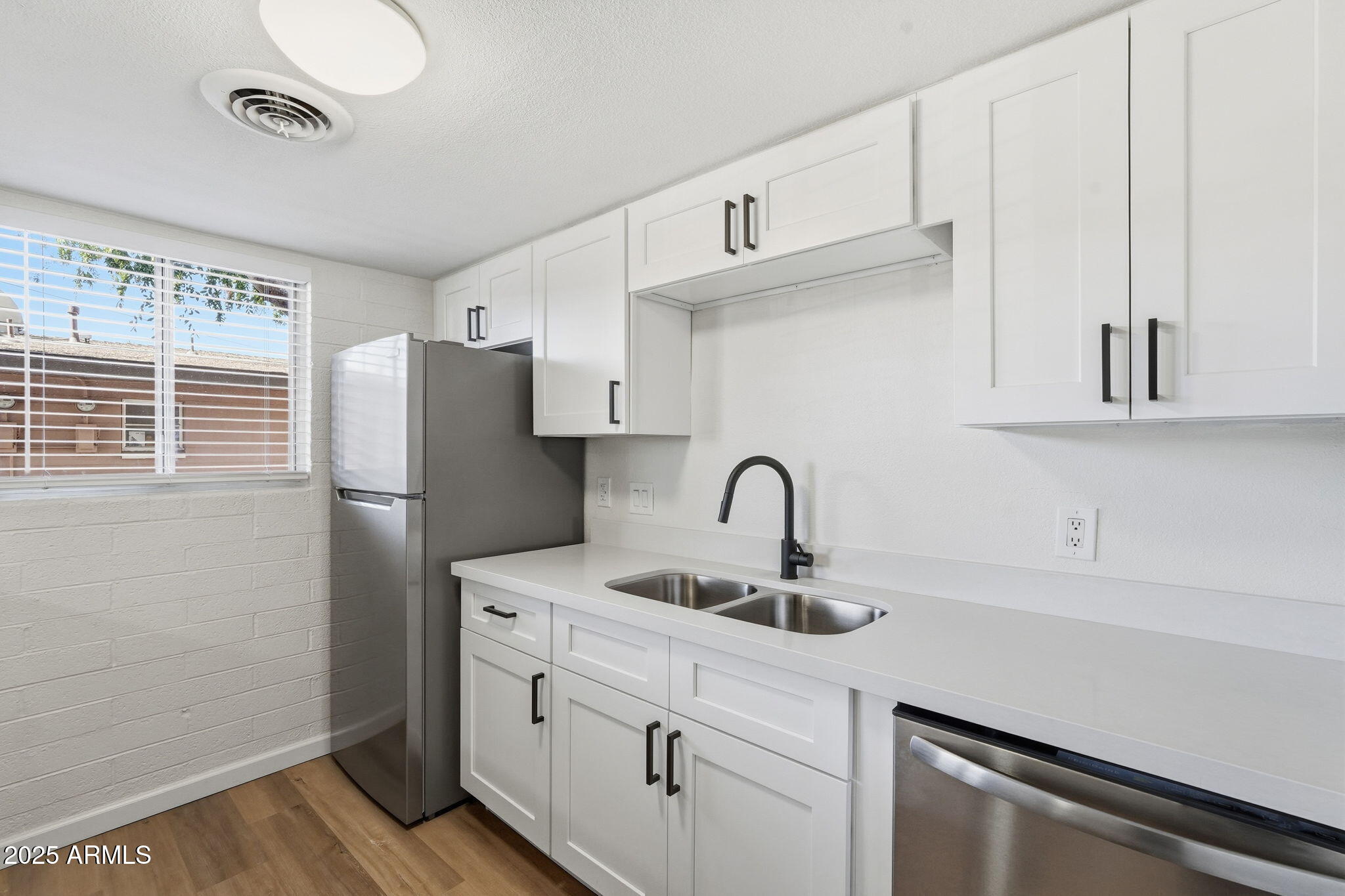 6544 North 12th Street, Unit 19 Phoenix, AZ 85014 - Photo 4 of 44 a kitchen with stainless steel appliances a sink cabinets and a window