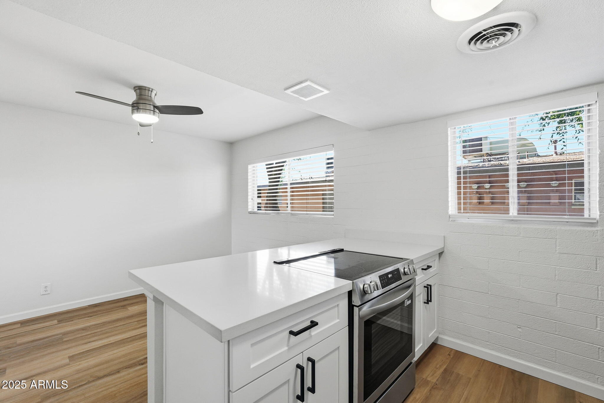 6544 North 12th Street, Unit 19 Phoenix, AZ 85014 - Photo 5 of 44 a kitchen with a stove cabinets and a window